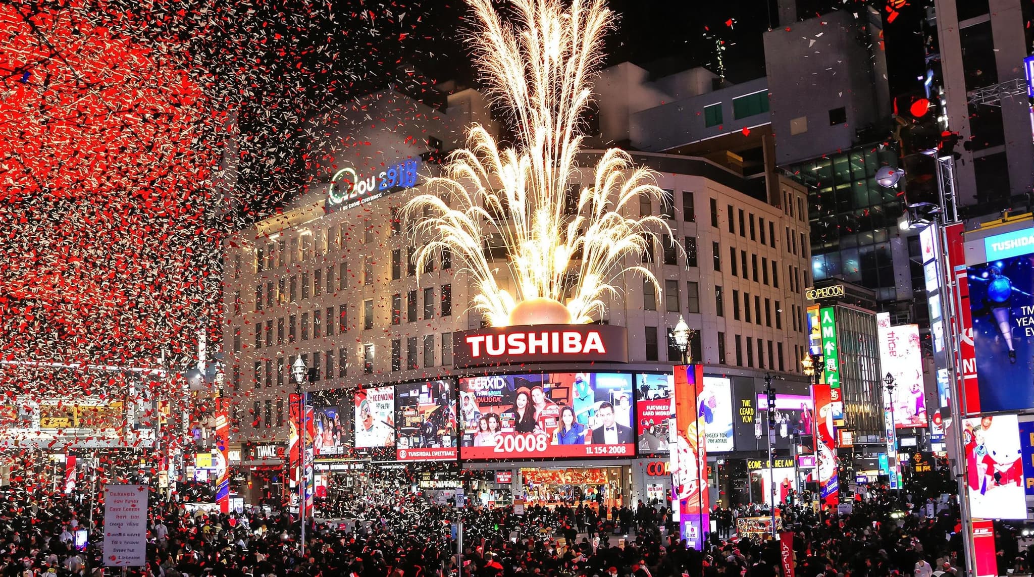 Times Square ball drop New Year’s Eve countdown to 2008 Toshiba countdown clock with popping colorful confetti machine and fireworks 